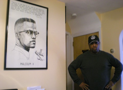 Chuck D with poster of Malcolm X